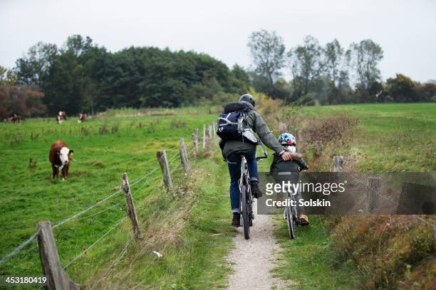 Father and son cycling together in nature