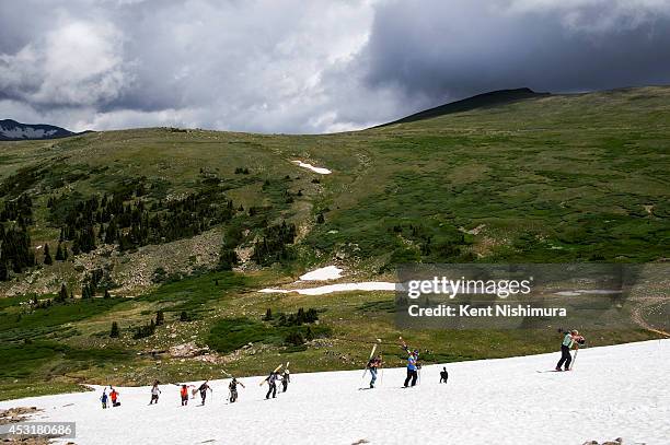 Skiers hike up Mt. Epworth for the 49th running of the Epworth Cup, an unofficial ski race atop Corona Pass on Sunday, July 13, 2014 in Winter Park,...