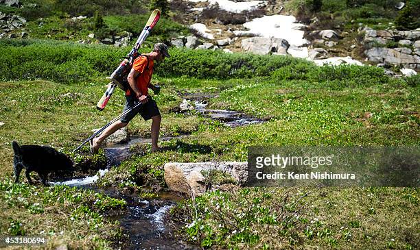 Dustin Rhoads, of Winter Park, walks over a small creek as he heads to the starting line of the 49th running of the Epworth Cup, an unofficial ski...