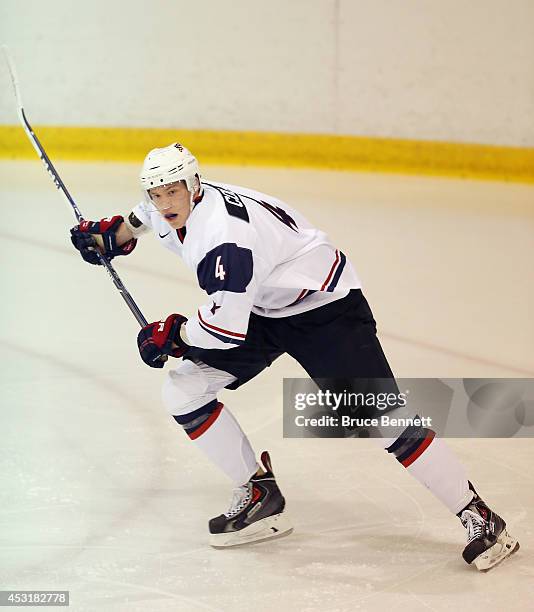 Ryan Collins of USA White skates against Team Finland during the 2014 USA Hockey Junior Evaluation Camp at the Lake Placid Olympic Center on August...