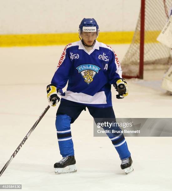 Mika Ilvonen of Team Finland skates against USA White during the 2014 USA Hockey Junior Evaluation Camp at the Lake Placid Olympic Center on August...