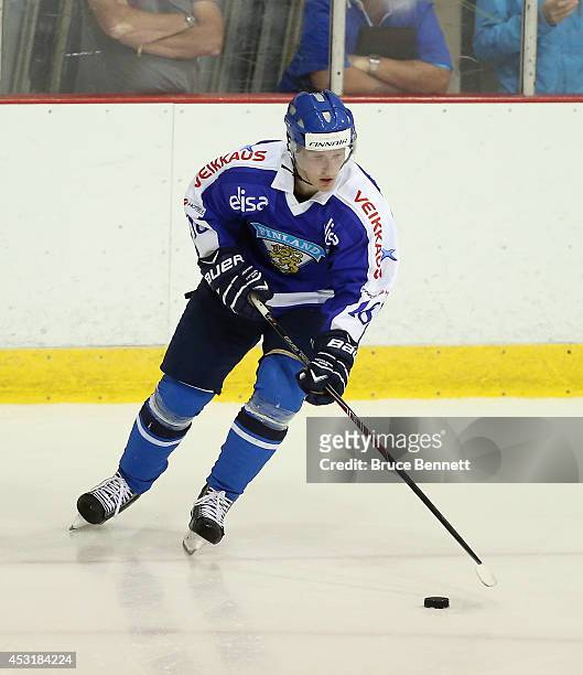 Saku Kinnunen of Team Finland skates against USA White during the 2014 USA Hockey Junior Evaluation Camp at the Lake Placid Olympic Center on August...