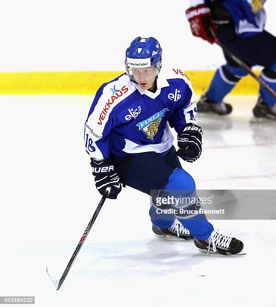 Saku Kinnunen of Team Finland skates against USA White during the 2014 USA Hockey Junior Evaluation Camp at the Lake Placid Olympic Center on August...