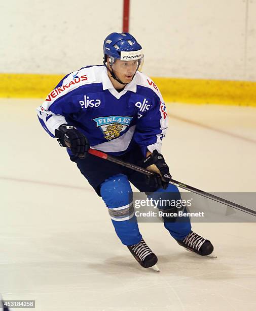 Aleksi Mustonen of Team Finland skates against USA White during the 2014 USA Hockey Junior Evaluation Camp at the Lake Placid Olympic Center on...
