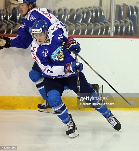 Atte Makinen of Team Finland skates against USA White during the 2014 USA Hockey Junior Evaluation Camp at the Lake Placid Olympic Center on August...