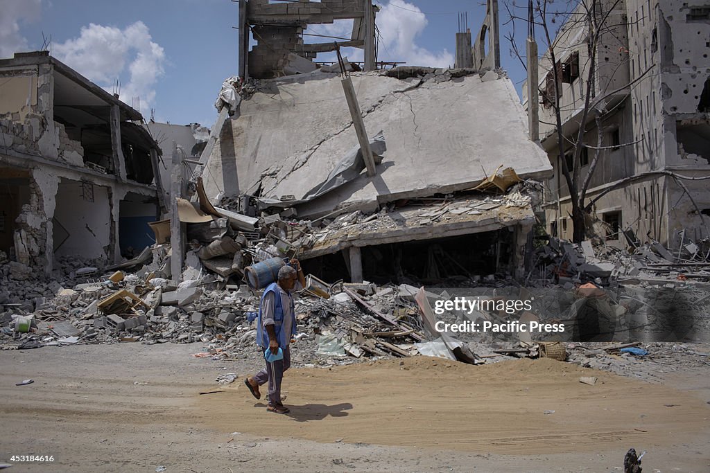Palestinians inspect destroyed houses in Beit Hanoun in the...