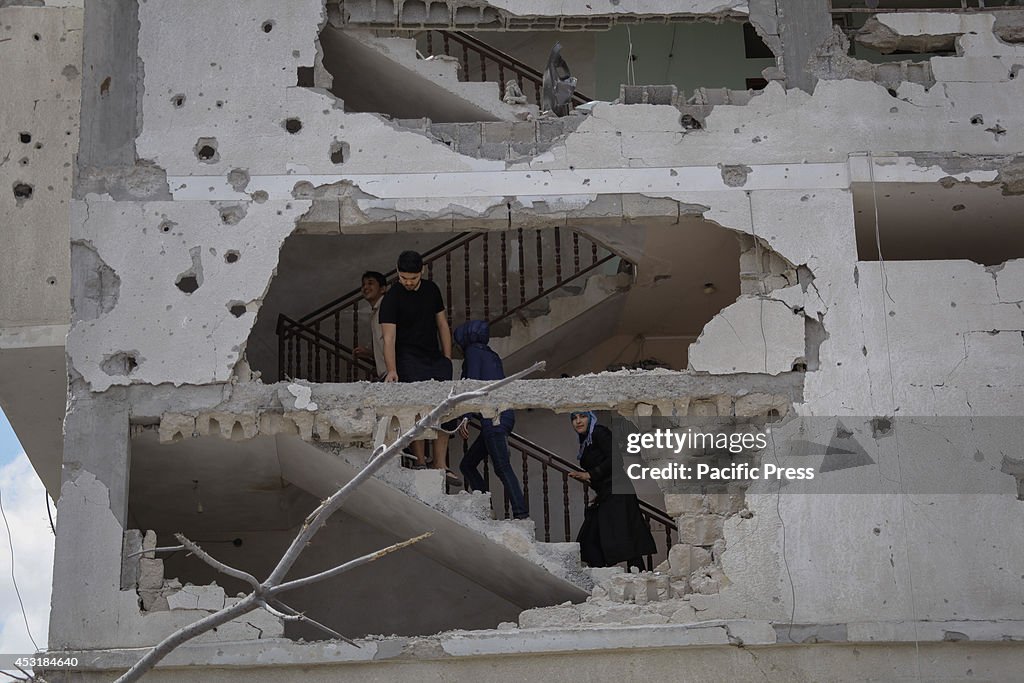 Palestinians inspect destroyed houses in Beit Hanoun in the...