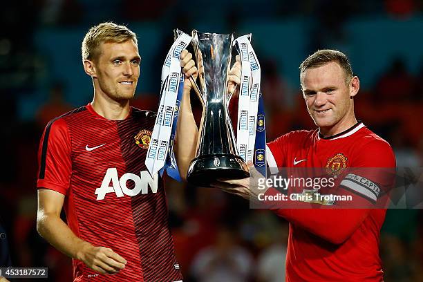 Darren Fletcher of Manchester United and Wayne Rooney of Manchester United lift the winners trophy following their 3-1 victory over Liverpool in the...