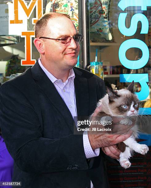 Grumpy Cat and Bryan Bundesen arrive at "The Grumpy Guide To Life: Observations By Grumpy Cat" Book Launch Party at Kitson on August 4, 2014 in Santa...