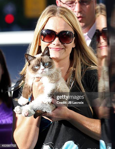 Grumpy Cat and Tabatha Bundesen arrive at "The Grumpy Guide To Life: Observations By Grumpy Cat" Book Launch Party at Kitson on August 4, 2014 in...