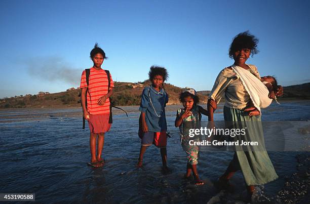 Aetas walking on an ash-filled riverbed near Mount Pinatubo. Their village is nearby. Over 900 people died when Mount Pinatubo erupted in June 1991....