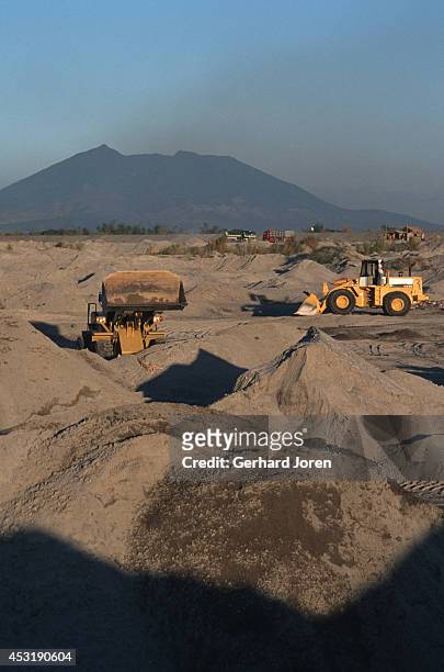Work vehicles moving ash after the volcanic eruption of Mount Pinatubo in June 1995. Pinatubo stood about 1745 meters above sea level before the June...