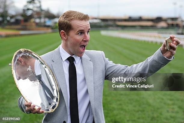 Jockey Tommy Berry takes a selfie as he poses with The Cox Plate trophy during the 2014 Caulfield Cup and Sportingbet Cox Plate nominations...