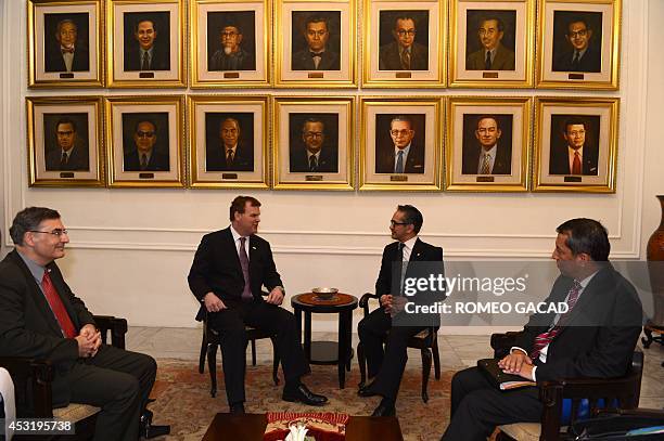Canadian Foreign Minister John Baird and his Indonesian counterpart Marty Natalegawa meet before their bilateral meeting in Jakarta on August 5, 2014...