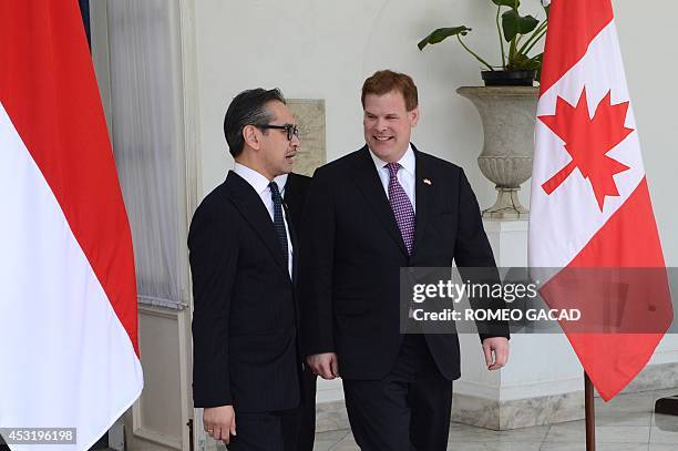 Indonesian Foreign Minister Marty Natalegawa sends off Canadian Foreign Minister John Baird following their bilateral meeting in Jakarta on August 5,...
