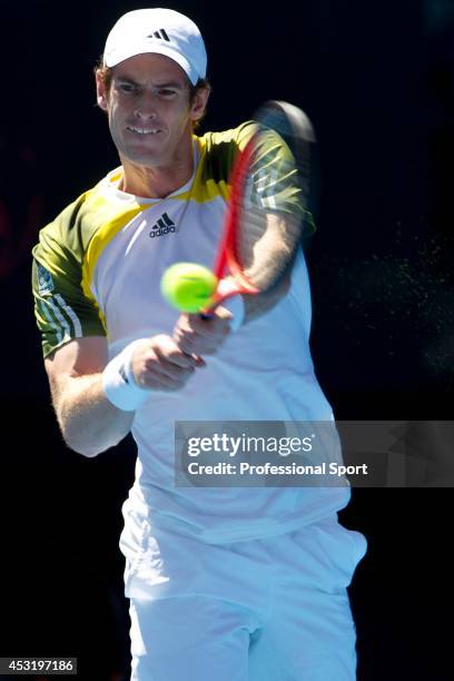 Andy Murray of Great Britain plays a backhand in his third round match against Ricardas Berankis of Lithuania during day six of the 2013 Australian...