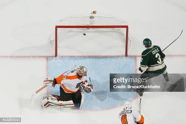 Charlie Coyle of the Minnesota Wild scores a goal against goalie Ray Emery of the Philadelphia Flyers during the game on December 2, 2013 at the Xcel...