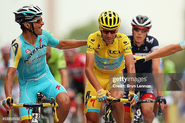 Michele Scarponi of Italy and the Astana Pro Team congratulates team mate and Tour de France winner Vincenzo Niabli of Italy as he crosses the...