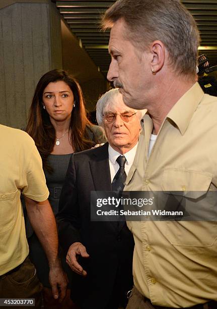 Bernie Ecclestone, the head of Formula One racing, and his wife Fabiana Flosi depart the Oberlandesgericht Muenchen courthouse after judges agreed to...