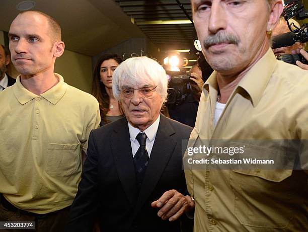 Bernie Ecclestone, the head of Formula One racing, and his wife Fabiana Flosi depart the Oberlandgericht Muenchen courthouse after judges agreed to...