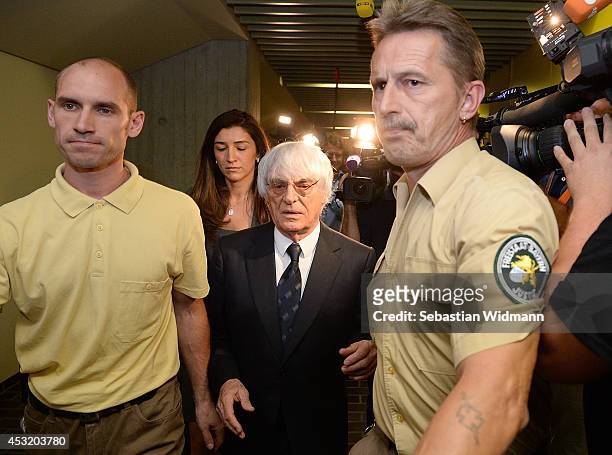 Bernie Ecclestone, the head of Formula One racing, and his wife Fabiana Flosi depart the Oberlandesgericht Muenchen courthouse after judges agreed to...