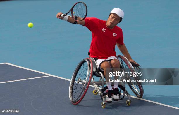 Japan's Shingo Kunieda returns against Netherlands' Ronald Vink in the semi-final of the men's singles wheelchair tennis competition at the London...