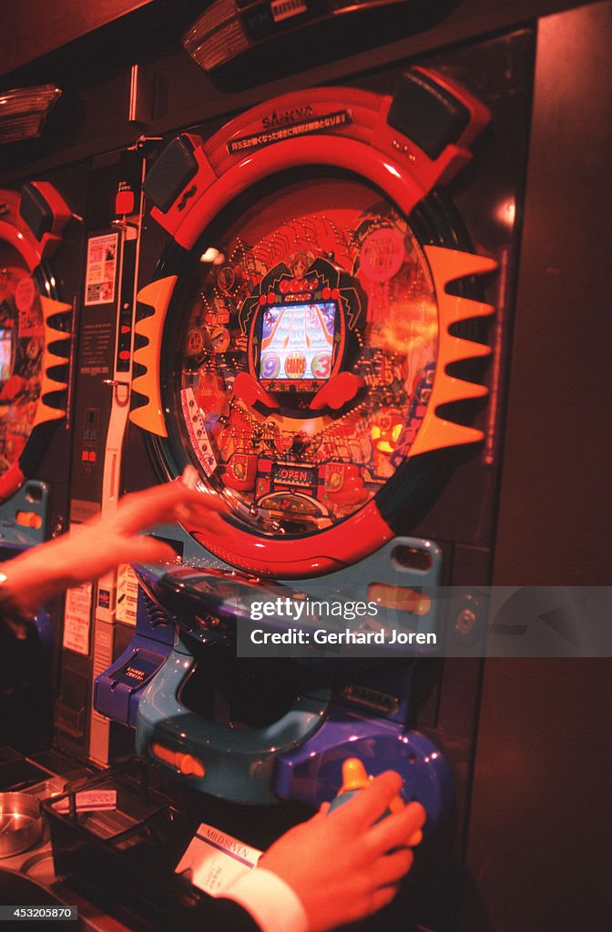 A player manipulates a pachinko machine at the Maruhan...