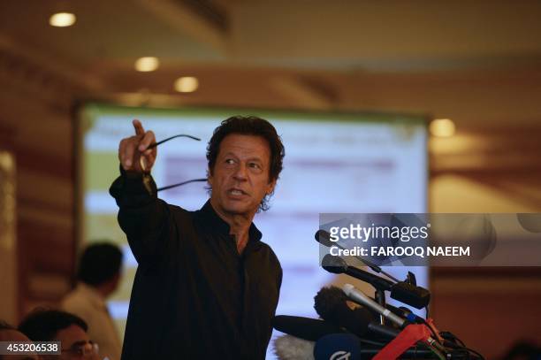 Former Pakistani cricketer and opposition leader Imran Khan gestures during a press conference in Islamabad on August 5, 2014. Khan announced he...