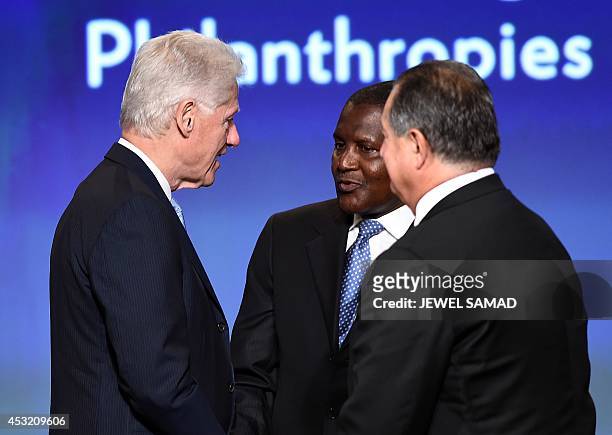 Former US President Bill Clinton speaks with Aliko Dangote , President and CEO, Dangote Group, and Andrew N. Liveris, President, Chairman & CEO, at...