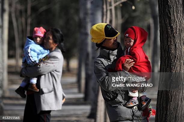 China-US-health-surrogacy,FEATURE by FELICIA SONMEZ Two Chinese families are seen at a park in Beijing on November 26, 2013. For decades China has...