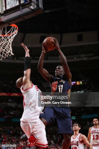 Jrue Holiday of the New Orleans Pelicans is fouled by Joakim Noah of the Chicago Bulls while going to the basket in the closing seconds of the third...