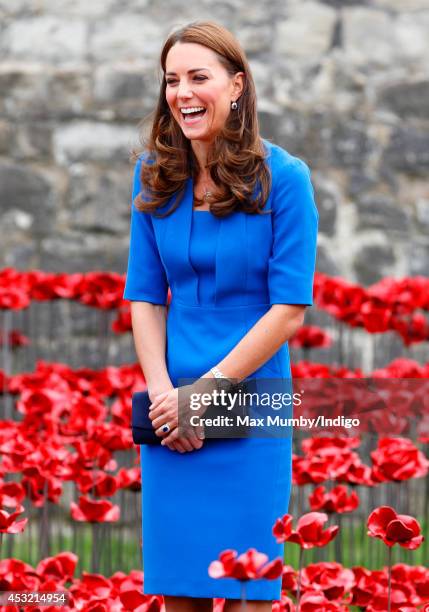 Catherine, Duchess of Cambridge walks through a poppy field art installation entitled 'Blood Swept Lands and Seas of Red' by artist Paul Cummins, in...