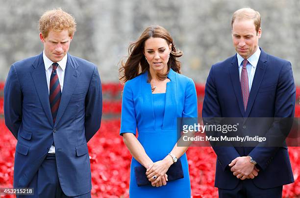 Prince Harry, Catherine, Duchess of Cambridge and Prince William, Duke of Cambridge visit the poppy field art installation entitled 'Blood Swept...