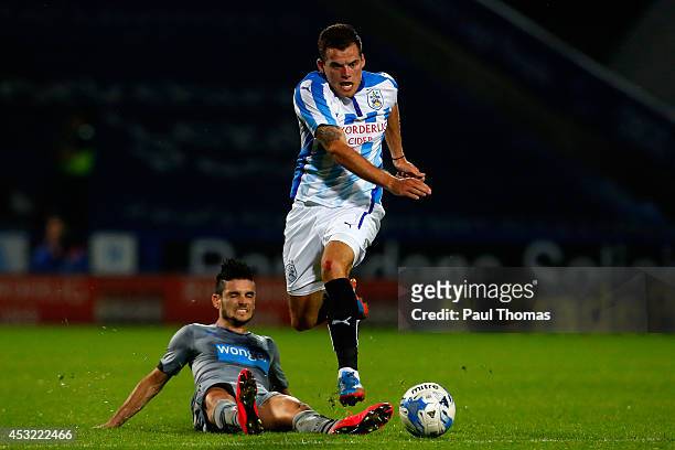 Jordan Sinnott of Huddersfield in action with Remy Cabella of Newcastle during the Pre Season Friendly match between Huddersfield Town and Newcastle...