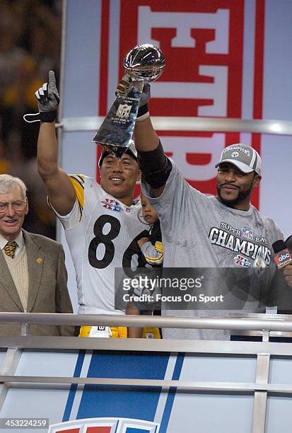 Hines Ward of the Pittsburgh Steelers holding his son and Jerome Bettis hold up the Vince Lombardi Trophy after the Steelers defeated the Seattle...