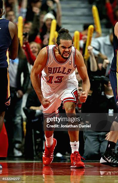 Joakim Noah of the Chicago Bulls celebrates after a dunk against the New Orleans Pelicans at the United Center on December 2, 2013 in Chicago,...
