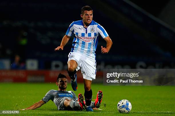 Jordan Sinnott of Huddersfield in action with Remy Cabella of Newcastle during the Pre Season Friendly match between Huddersfield Town and Newcastle...