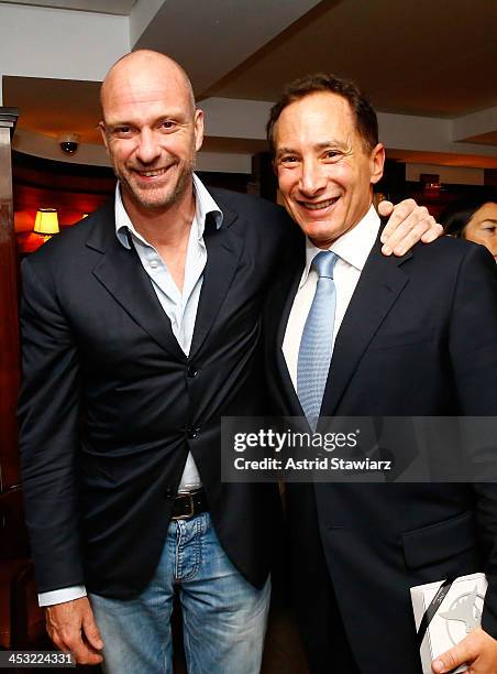 Racing driver Giuseppe Cipriani and CEO of Griffon Corp. Ron Kramer attend as IWC CEO Georges Kern celebrates with DuJour's Jason Binn for a pre-Art...