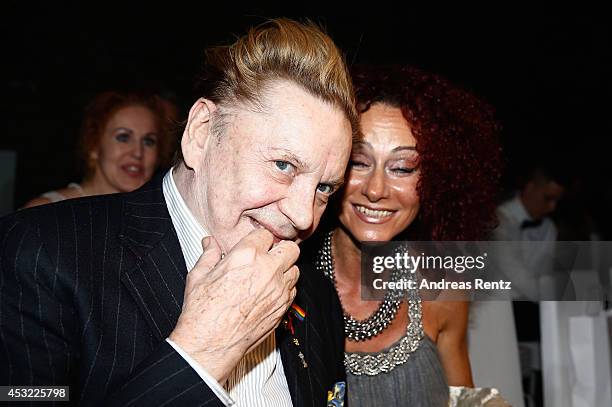 Helmut Berger and Christina aka Mausi Lugner attend the GarconF fashion show at Balloni-Hallen on August 5, 2014 in Cologne, Germany.