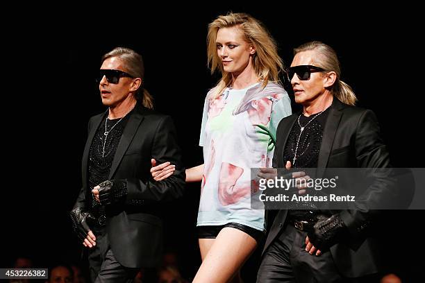 Arnold and Oskar Wess with model Anastassija Makarenko walk down the runway during GarconF fashion show at Balloni-Hallen on August 5, 2014 in...