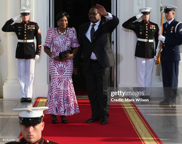 Malawi President Arthur Peter Mutharika and spouse Gertrude Hendrina Mutharika arrive at the North Portico of the White House for a State Dinner on...