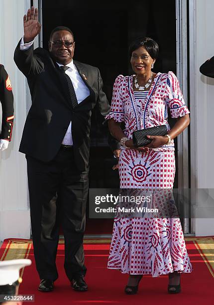 Malawi President Arthur Peter Mutharika and spouse Gertrude Hendrina Mutharika arrive at the North Portico of the White House for a State Dinner on...