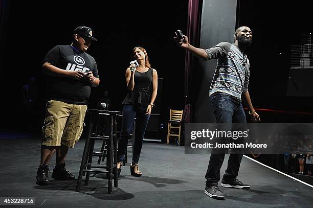 Fan plays a game of EA Sports' UFC against mixed martial artist Jon Jones after a UFC Q&A session at LA Live on August 5, 2014 in Los Angeles,...