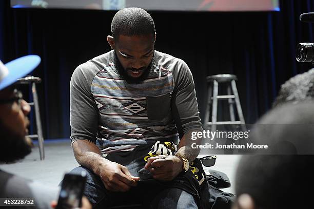 Mixed martial artist Jon Jones signes an autograph after a UFC Q&A at LA Live on August 5, 2014 in Los Angeles, California.