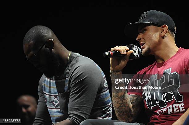 Mixed martial artist Dustin Poirier talks beside mixed martial artist Jon Jones during a UFC Q&A at LA Live on August 5, 2014 in Los Angeles,...