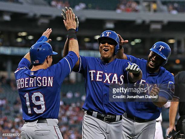 Dan Robertson, Adrian Beltre and Elvis Andrus of the Texas Rangers celebrate scoring runs in the 2nd inning against the Chicago White Sox at U.S....