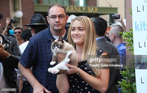 Bryan Bundesen and his sister Tabatha Bundesen holding Grumpy Cat as they arrive at "The Grumpy Guide to Life: Observations By Grumpy Cat" book...