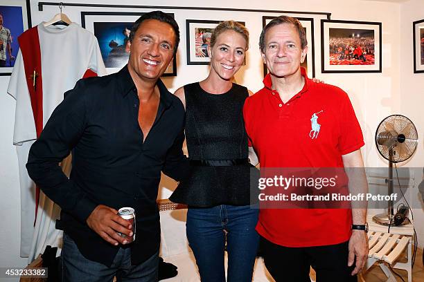 Singer Dany Brillant, his wife Nathalie Moury and actor Francis Huster pose backstage after "L'Affrontement" play during the 30th Ramatuelle Festival...
