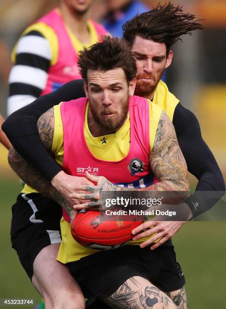 Dane Swan, coming back from a foot injury, is tackled by Tyson Goldsack during a Collingwood Magpies AFL training session at Westpac Centre on August...