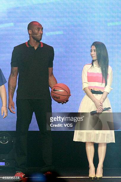 Player Kobe Bryant and singer Hebe attend new product release conference of Lenovo on August 5, 2014 in Beijing, China.